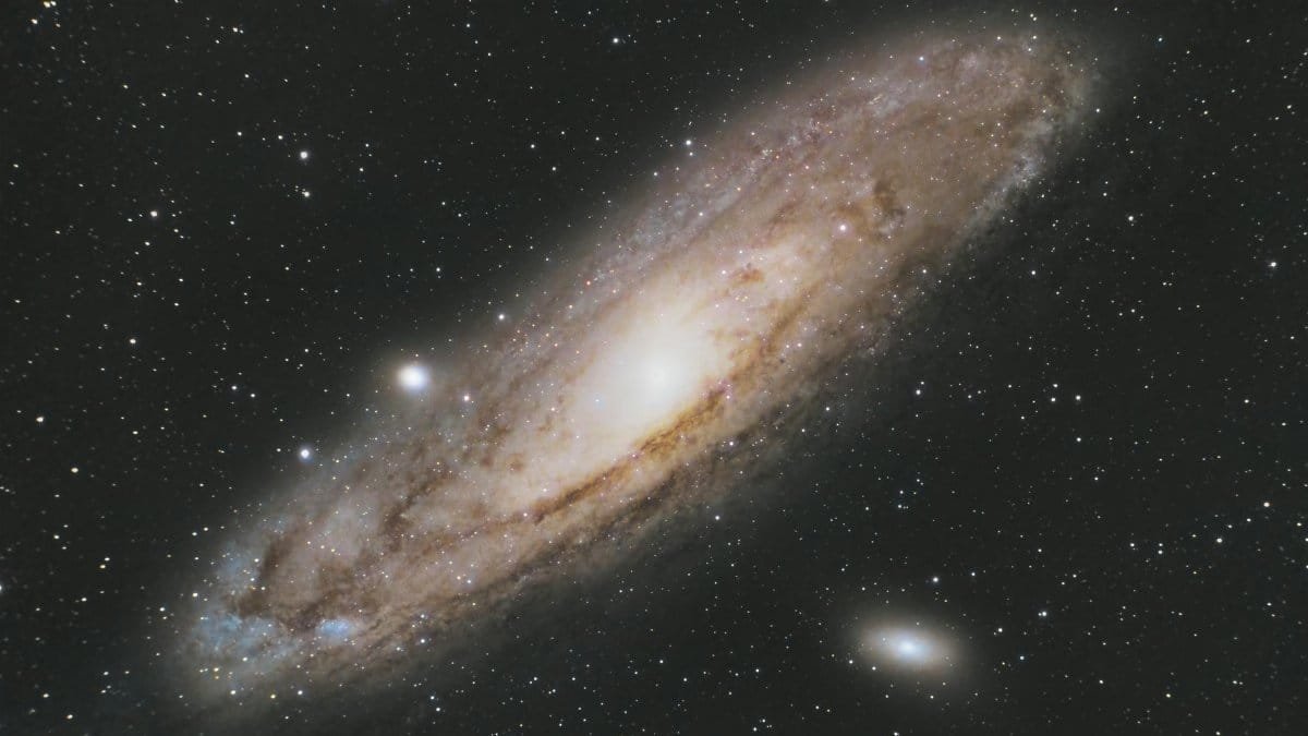 Astrophotography of the Andromeda Galaxy (Messier 31) in the star-filled night sky.