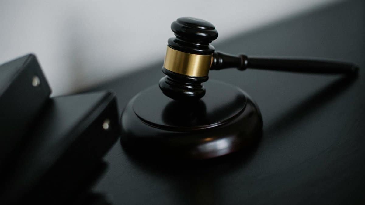 Close-up of a wooden gavel on a desk, symbolizing justice and legal authority.