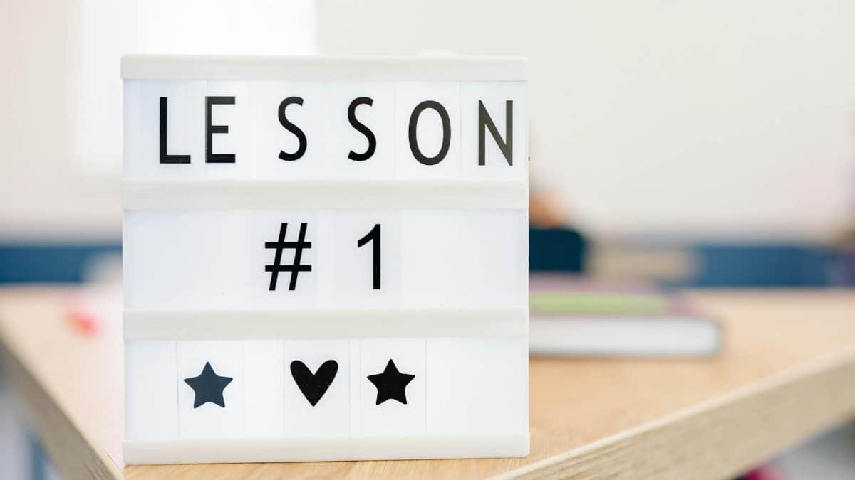 Lightbox sign displaying 'Lesson #1' in a classroom setting, symbolizing education and new beginnings.