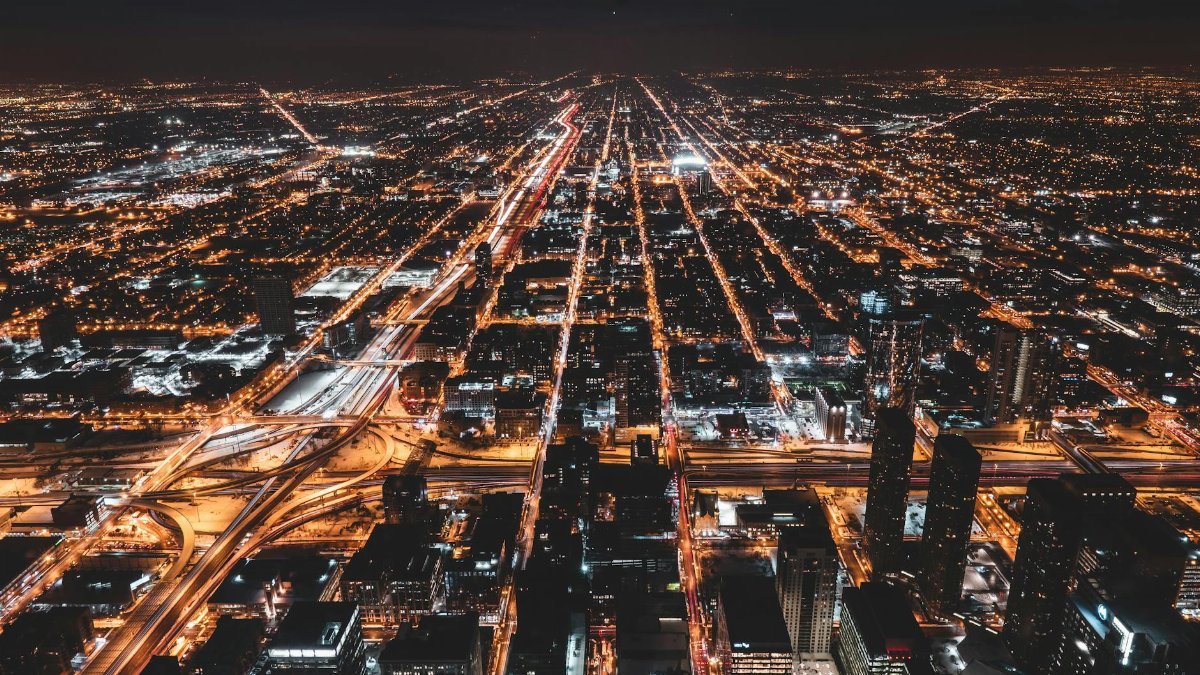 Stunning aerial view of Chicago's illuminated grid at night, showcasing urban cityscape lights.