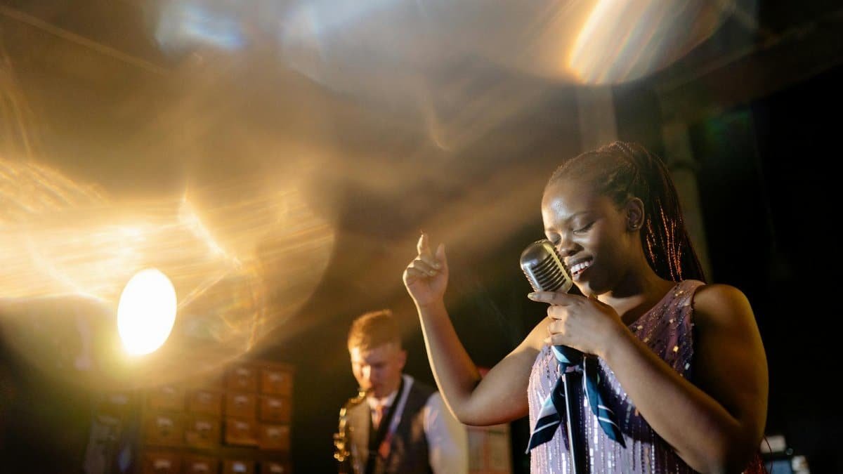 Vibrant live performance featuring a female singer and her band, capturing the essence of live music.