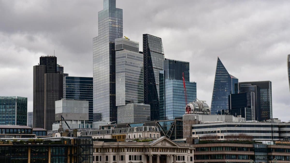 A dramatic view of London's city skyline featuring iconic modern skyscrapers.