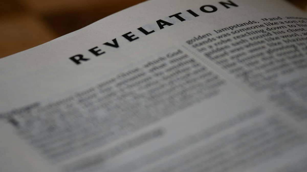 A close-up shot of the Book of Revelation from the Bible, emphasizing text.