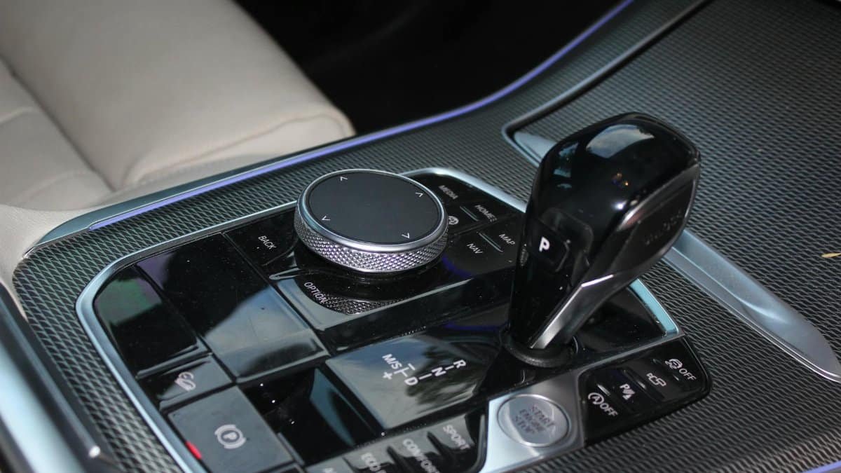 Close-up view of a luxury car's gear shift and controls in a modern vehicle.