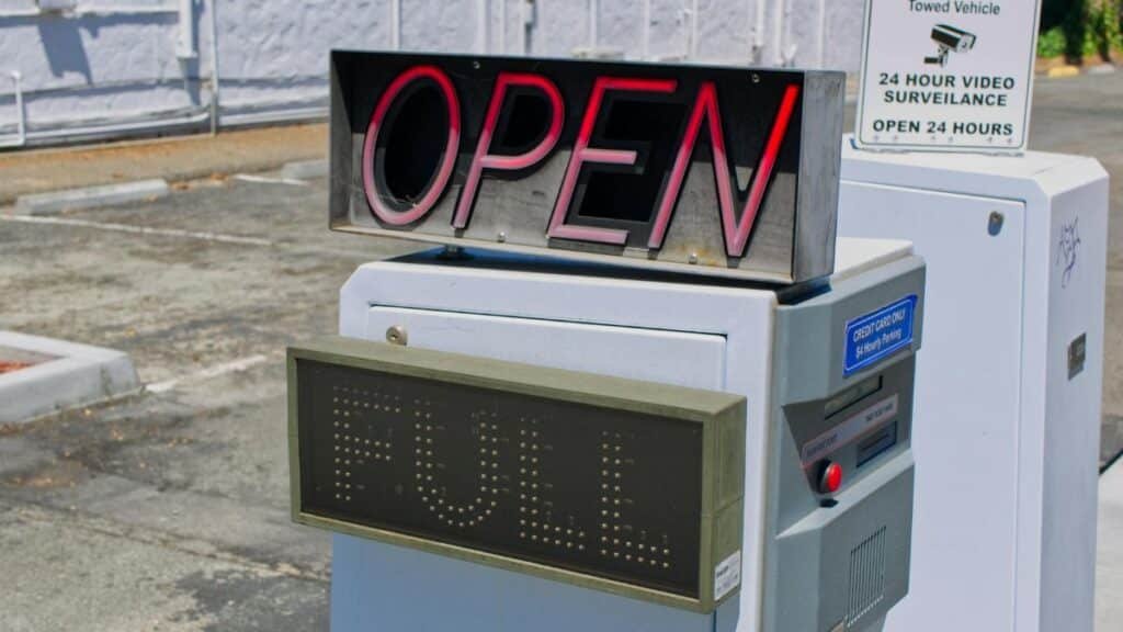 Photograph of a parking entrance showing 'Open' and 'Full' signs in daylight.