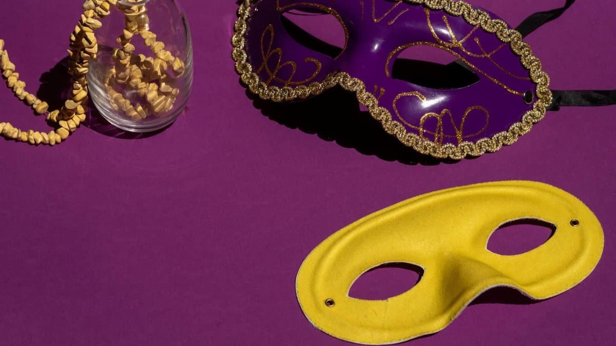 Colorful Mardi Gras masks showcase elegance with a purple and yellow contrast on a violet background.