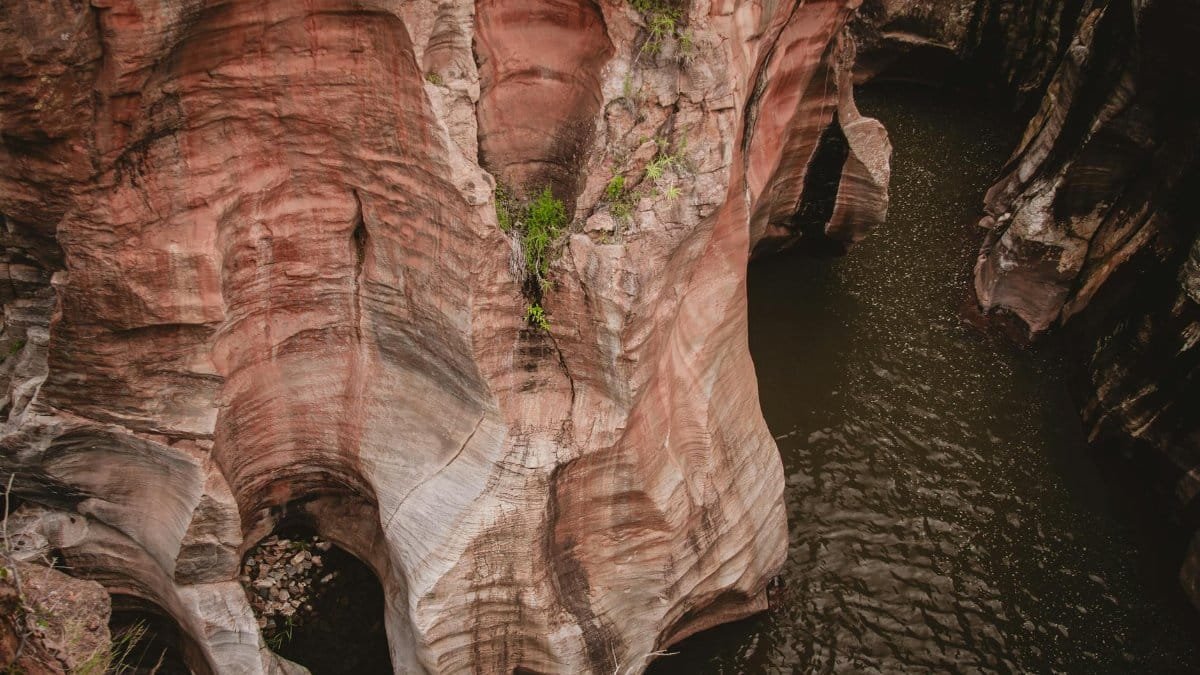 Explore the breathtaking geological formations of Bourke's Luck Potholes with dramatic cliffs and erosive patterns.