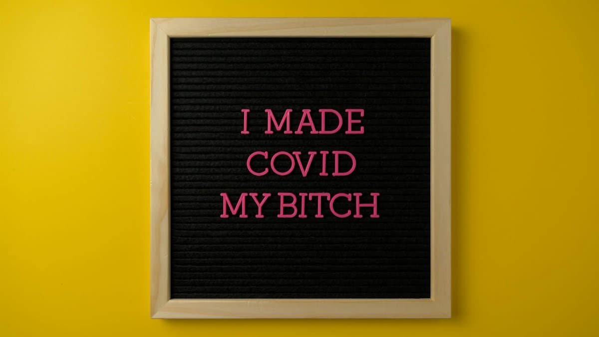 Strong message on a board symbolizing overcoming COVID-19 challenges with vibrant colors.