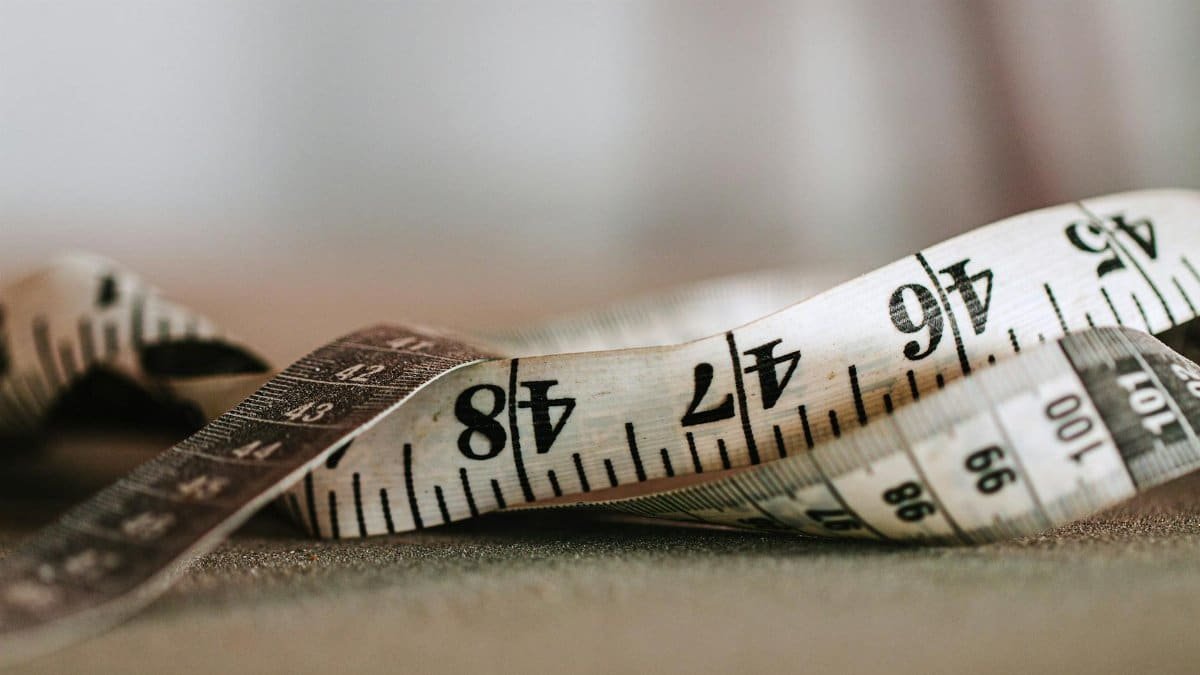 Detailed close-up of a measuring tape showing precise numbers and units