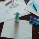 Children's art area with colorful drawings, crayons, and paints, showcasing creative activities.