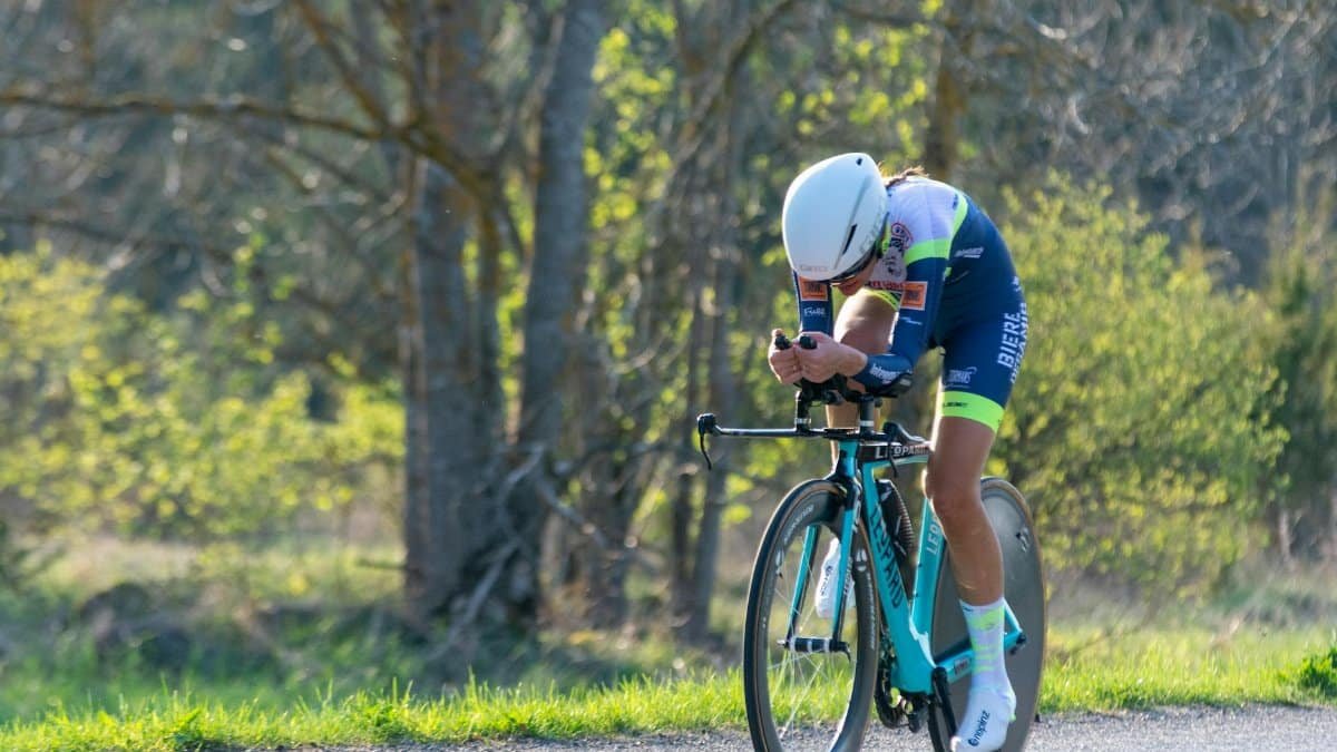 A determined cyclist racing through a scenic spring landscape. Perfect for sports themes.