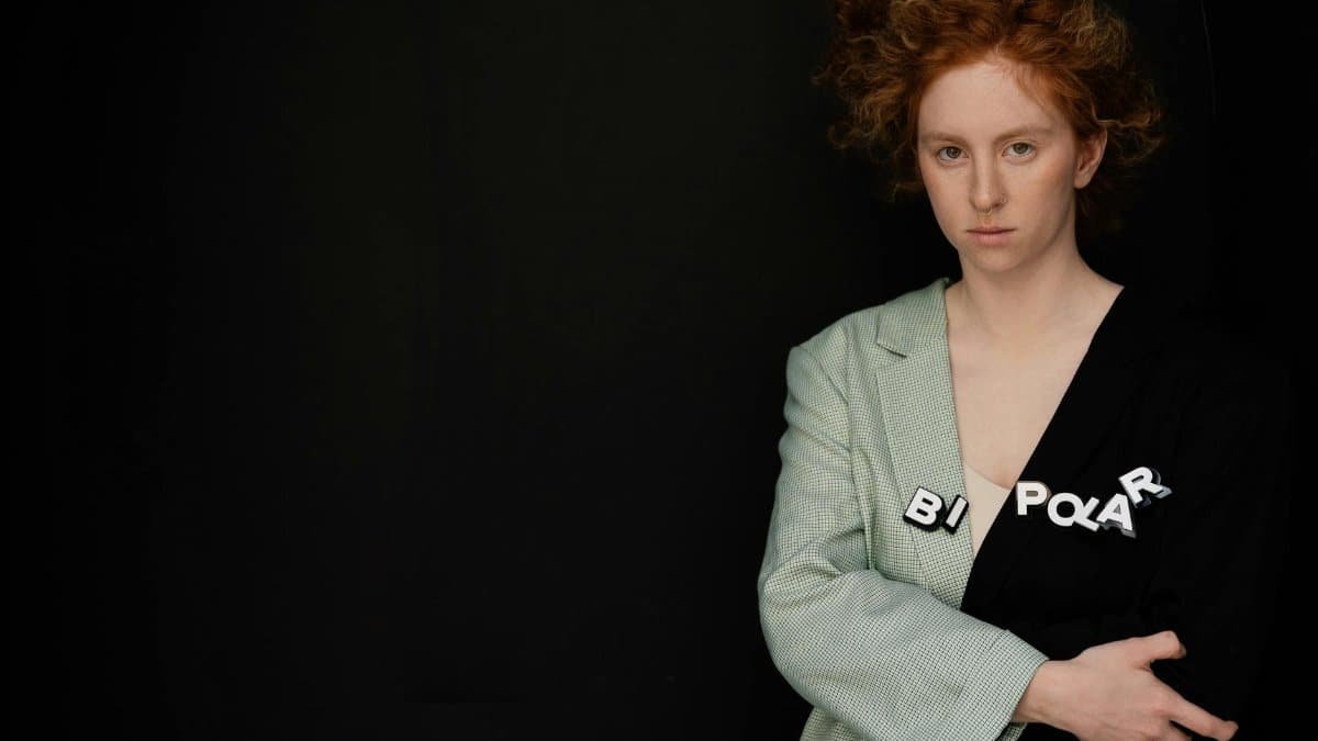 Artistic portrait of a woman with 'bipolar' text, expressing inner emotions and mental health themes.