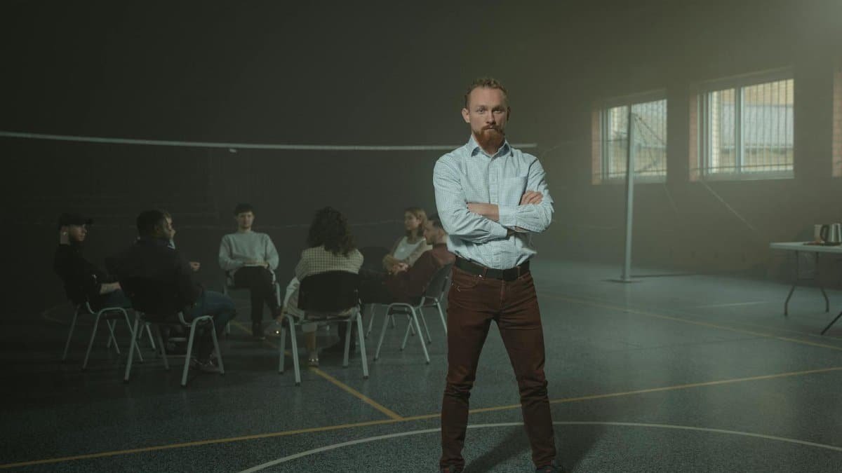 Group counseling session in a gym with a focus on peer support and mental health.