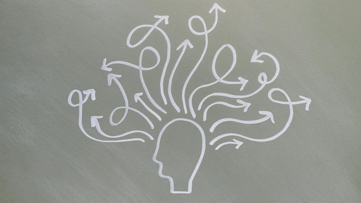 Conceptual chalk drawing illustrating mental health challenges with arrows representing thoughts.