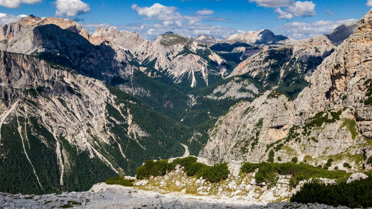 Breathtaking view of the Dolomites under clear blue skies, perfect for travel and adventure enthusiasts.