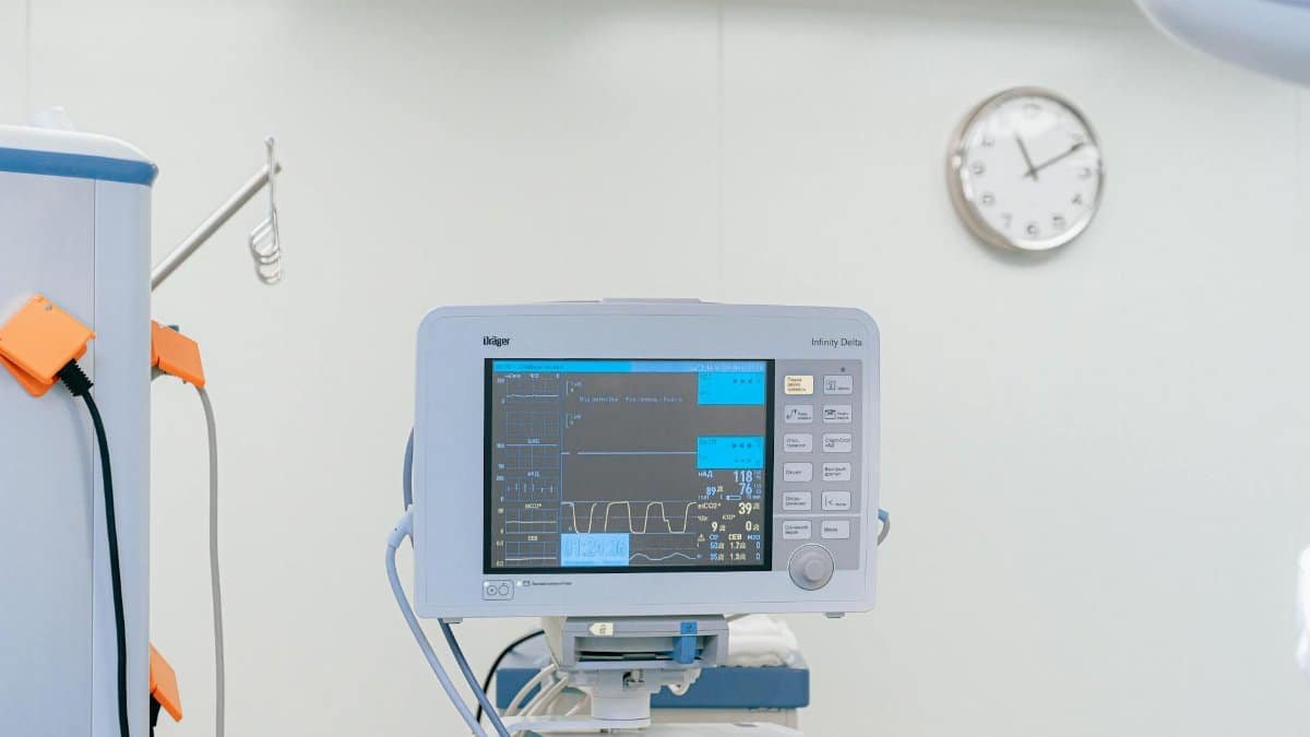 A modern heart rate monitor in a sterile hospital setting, showcasing medical technology.