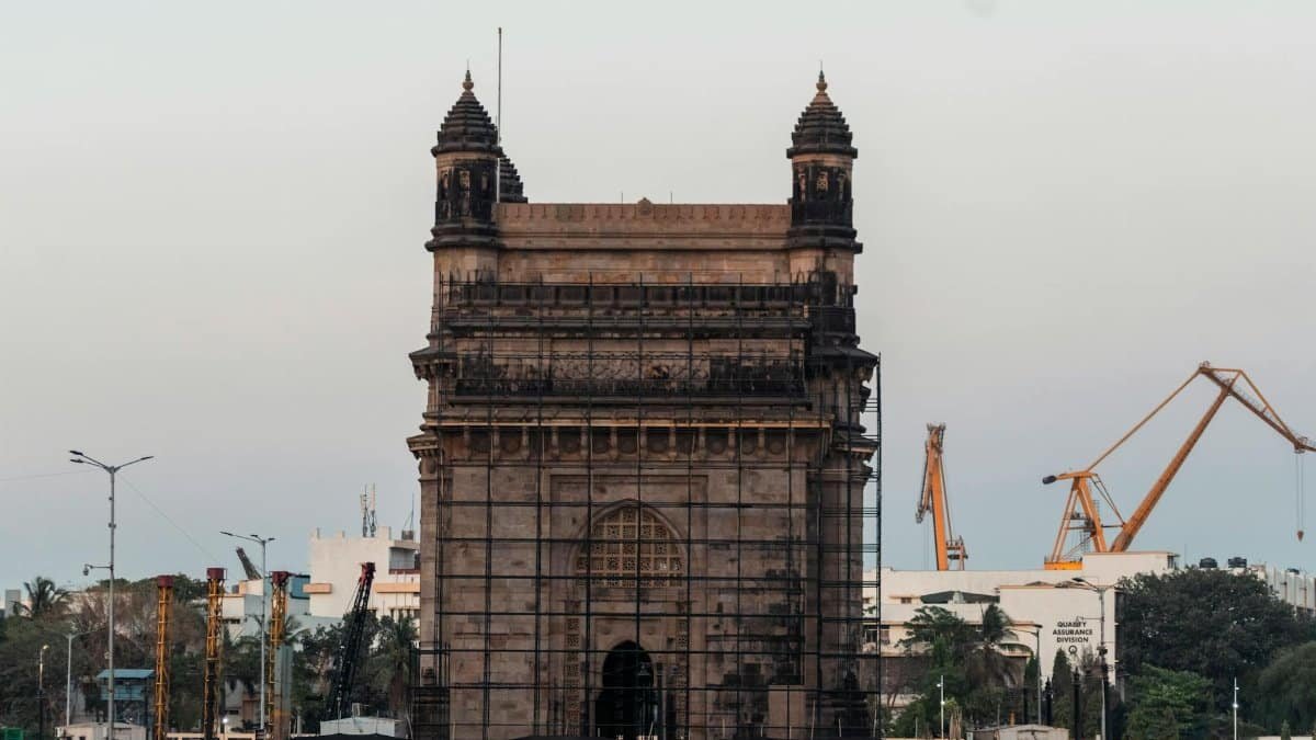 Iconic Gateway of India monument in Mumbai, a popular tourist attraction, captured at dusk.