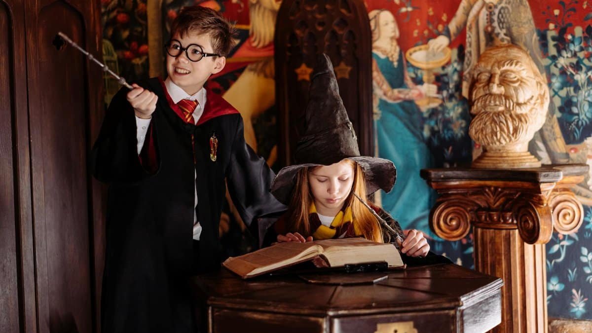 Children dressed as wizards engaged in magic-themed play, exploring spells in a fantasy setting.