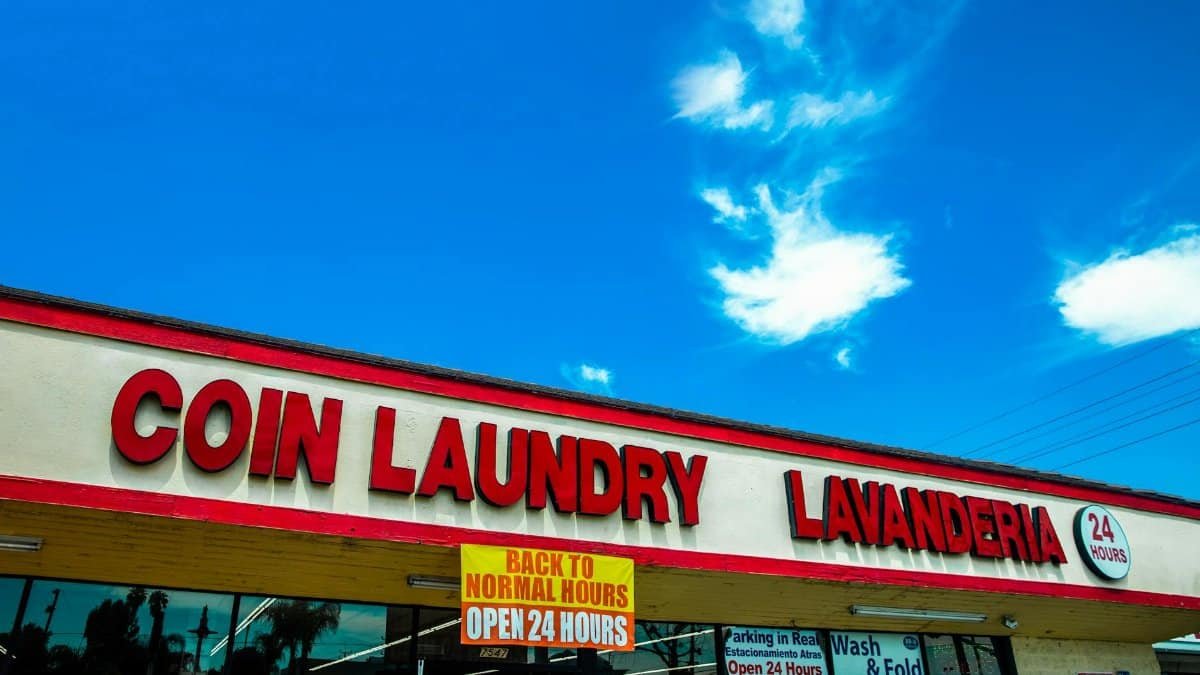 Exterior view of a coin laundry in Los Angeles, clearly marked with 24-hour service signage.