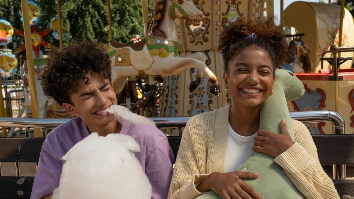 A cheerful moment at the amusement park with friends enjoying cotton candy and stuffed toys.