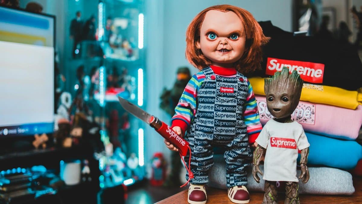 Quirky display featuring Chucky and Groot dolls in iconic Supreme streetwear style.