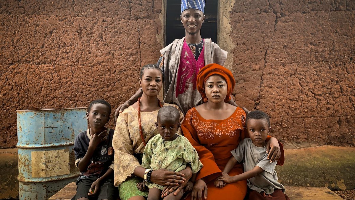 A joyful family in traditional Nigerian clothing, showcasing cultural heritage in Abeokuta, Nigeria.