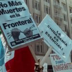 Protesters in Los Angeles rally for immigration rights with powerful messages on signs.