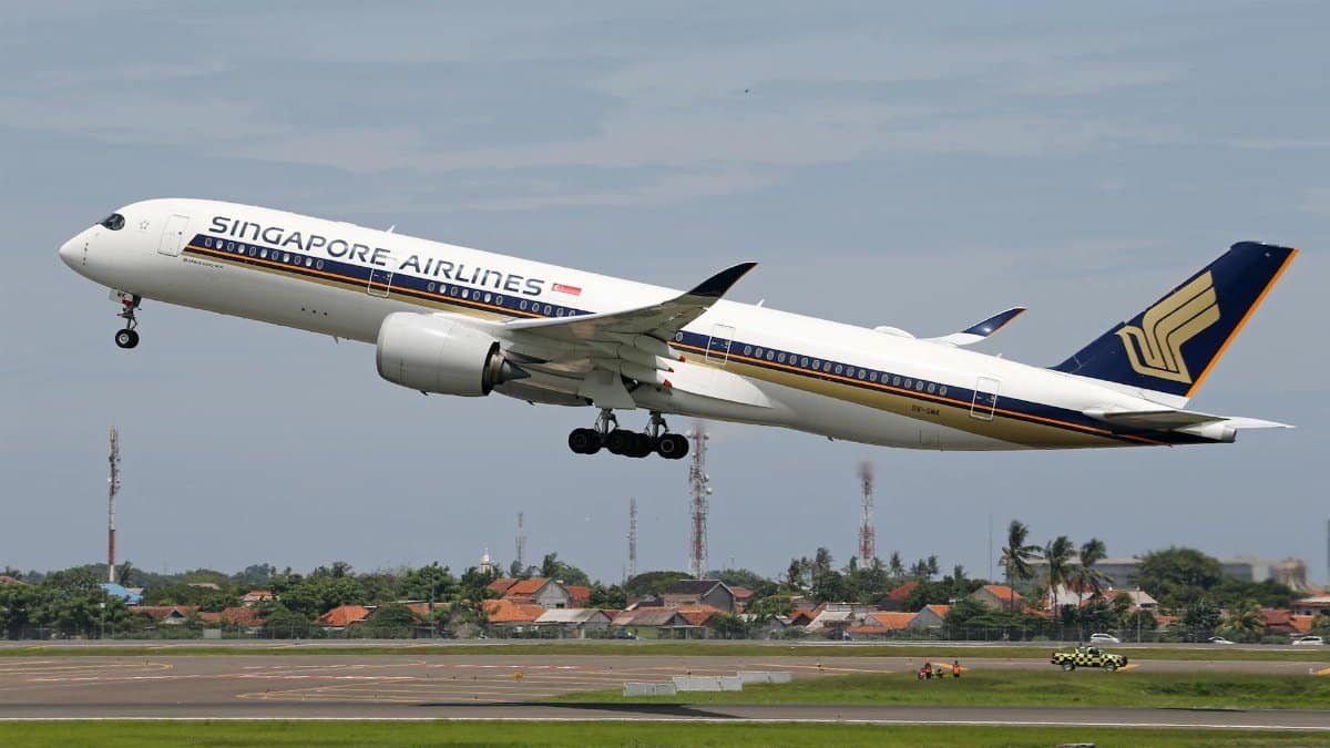 Singapore Airlines Airbus A350 taking off from an airport runway, showcasing air travel and transportation.