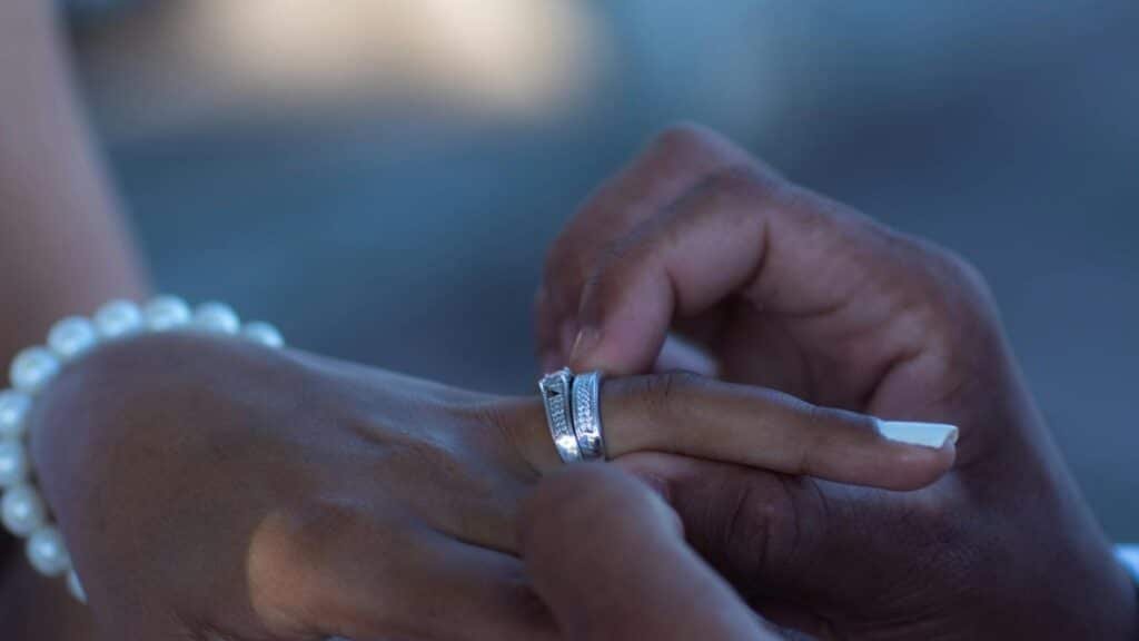 Intimate close-up of hands exchanging wedding ring in San Pedro, Dominican Republic.