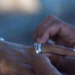 Intimate close-up of hands exchanging wedding ring in San Pedro, Dominican Republic.