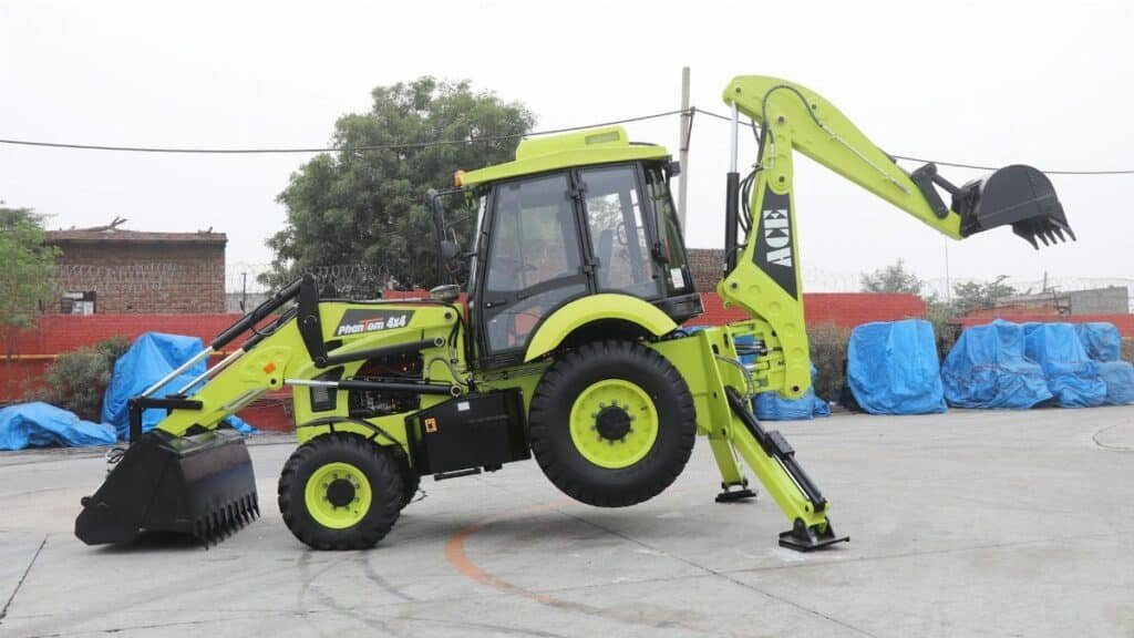 A vibrant ACE Phantom 4x4 backhoe loader is showcased in an outdoor setting in Faridabad, India.