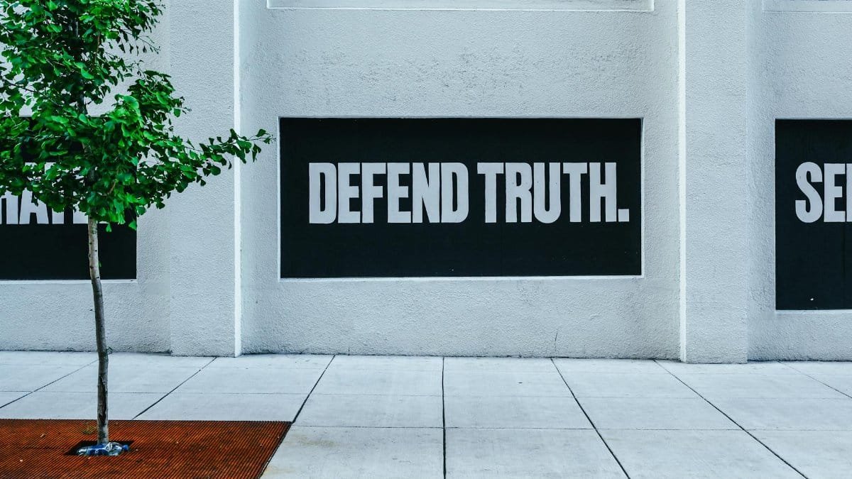 Street wall with message 'Defend Truth' reflects powerful expression and urban vibe.