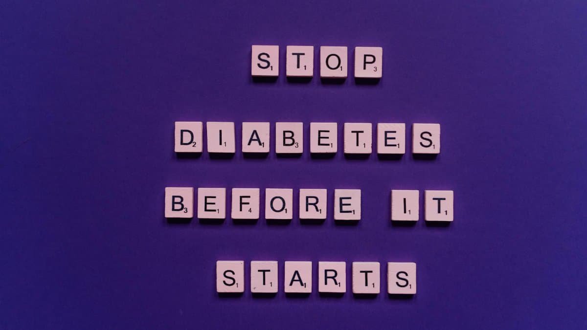 Creative Scrabble tile arrangement advocating diabetes prevention with a vivid purple background.