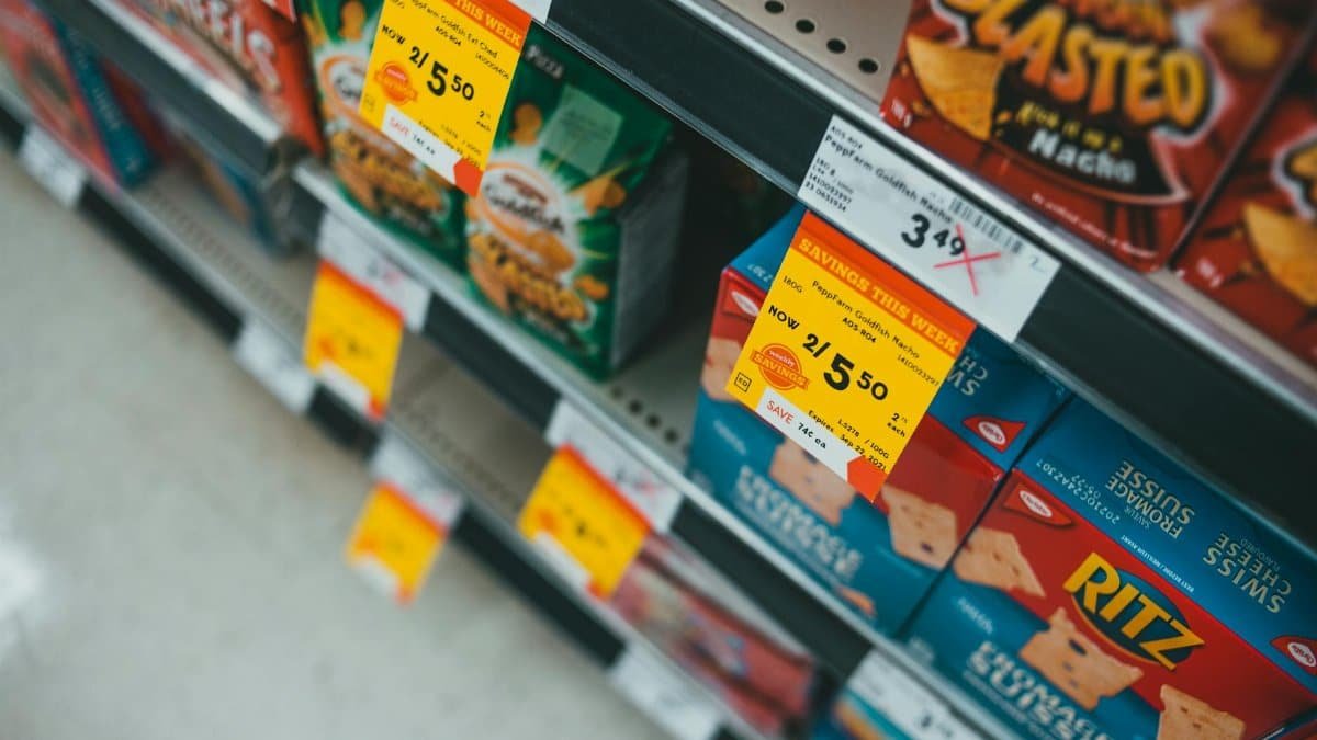 Supermarket aisle featuring discounted snacks with visible sale tags and prices.