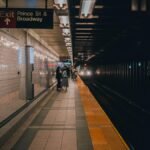 People waiting at Prince St subway platform in New York City, serene evening scene.