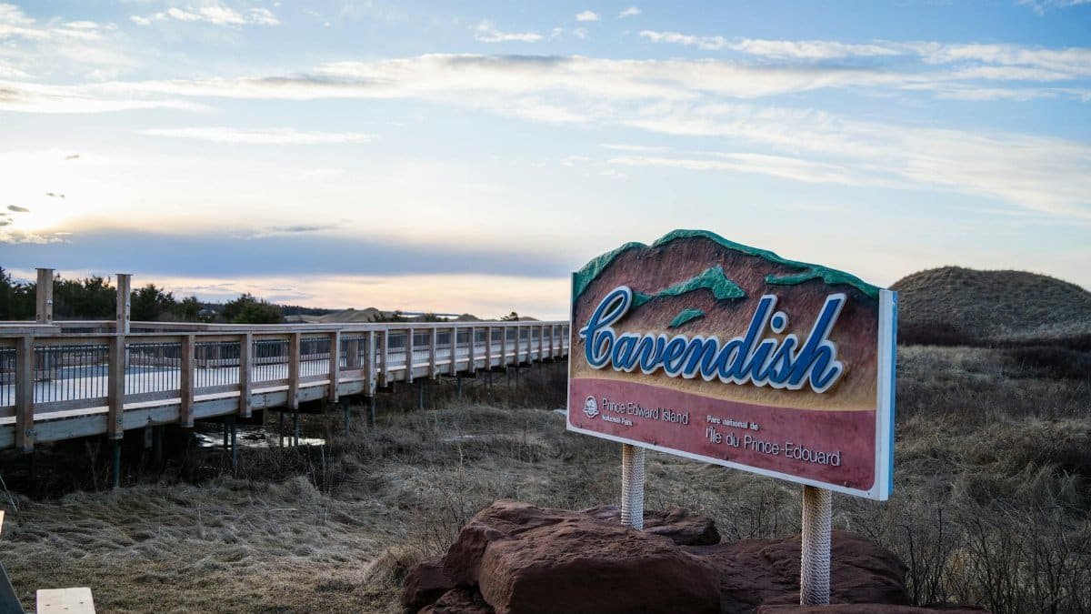 Cavendish sign by boardwalk under blue skies in Prince Edward Island, Canada.