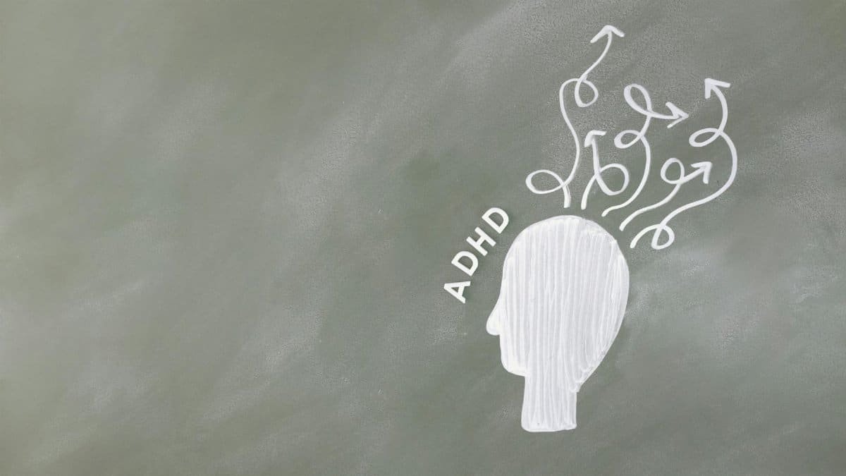 Illustration of ADHD and mental process with head-like outline on chalkboard.