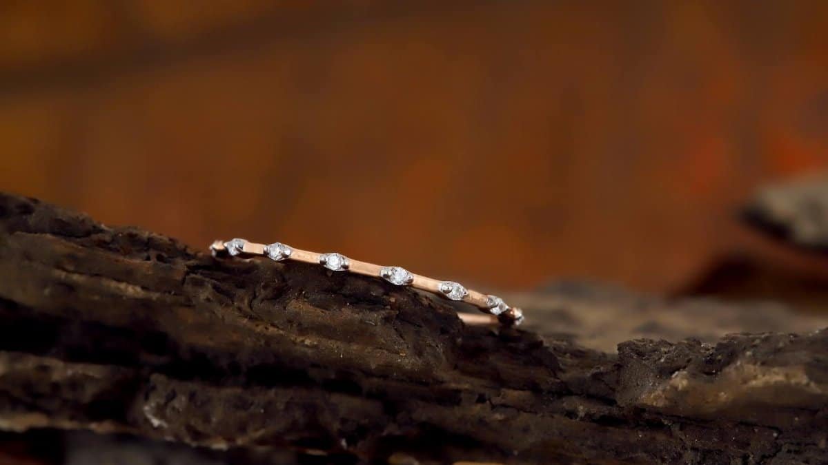 Minimalist diamond bracelet with a rustic backdrop, highlighting elegance and sophistication.