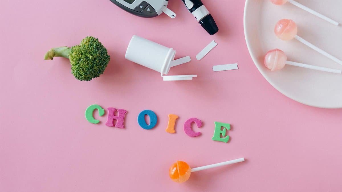 Conceptual image highlighting choice between health foods and sweets, symbolized by broccoli and lollipops.