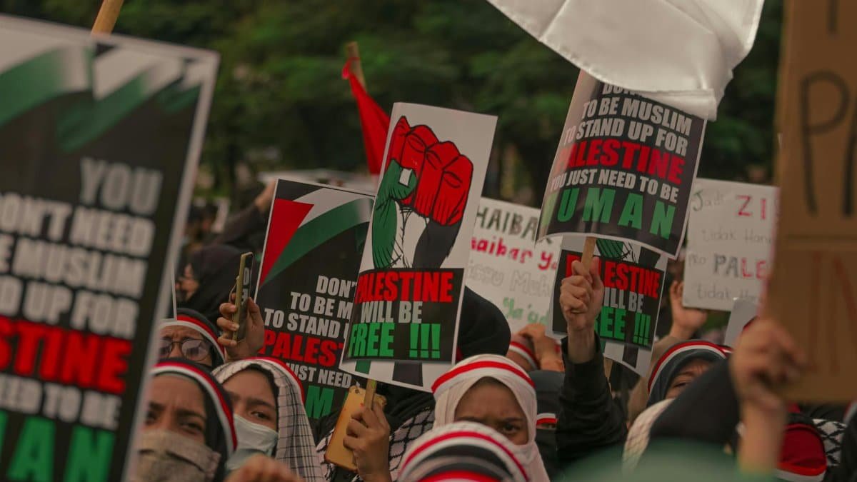 Demonstrators in Jakarta rally for Palestine with impactful signs and expressions of solidarity.