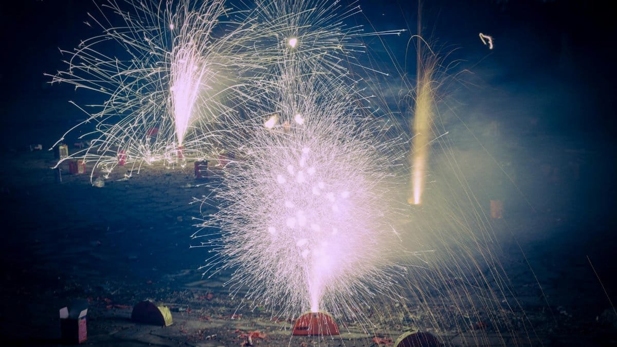 Explosive celebration of colorful fireworks lighting up the night outdoors.