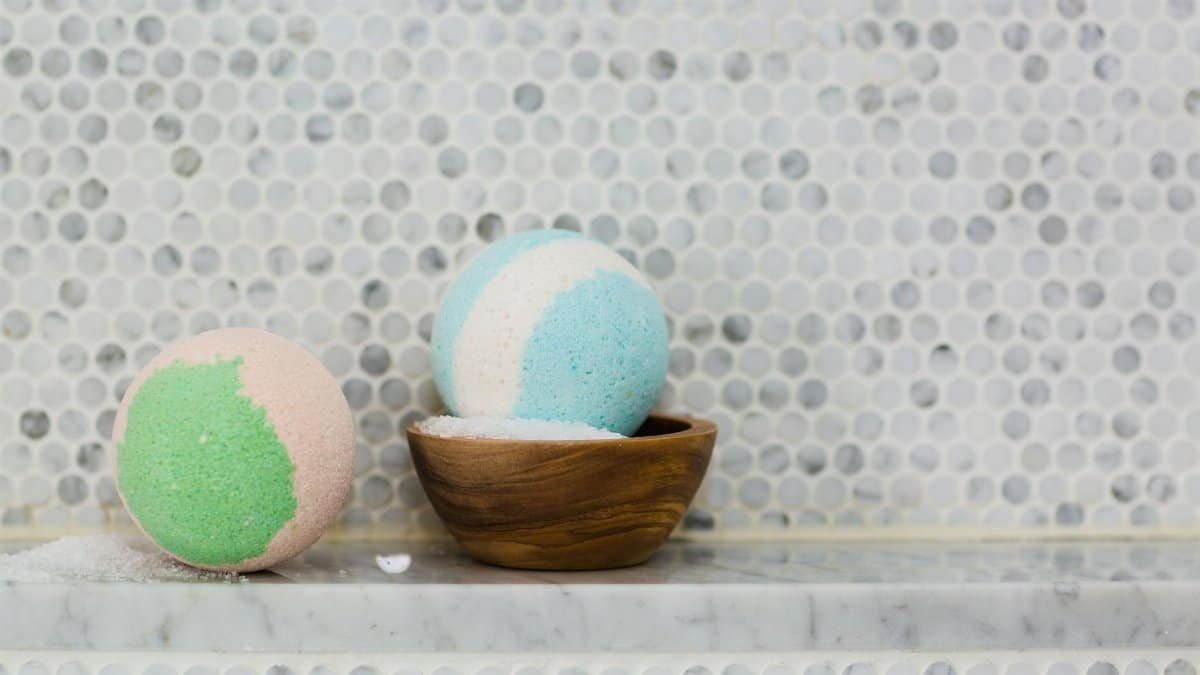 Colorful pastel bath bombs displayed on a marble surface for spa ambiance.