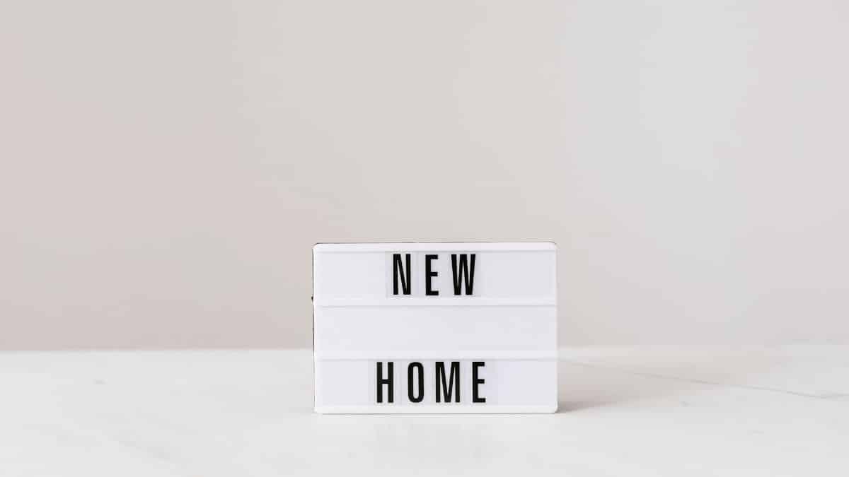 Minimalist lightbox with 'New Home' text on a modern gray background, perfect for real estate or interior design themes.