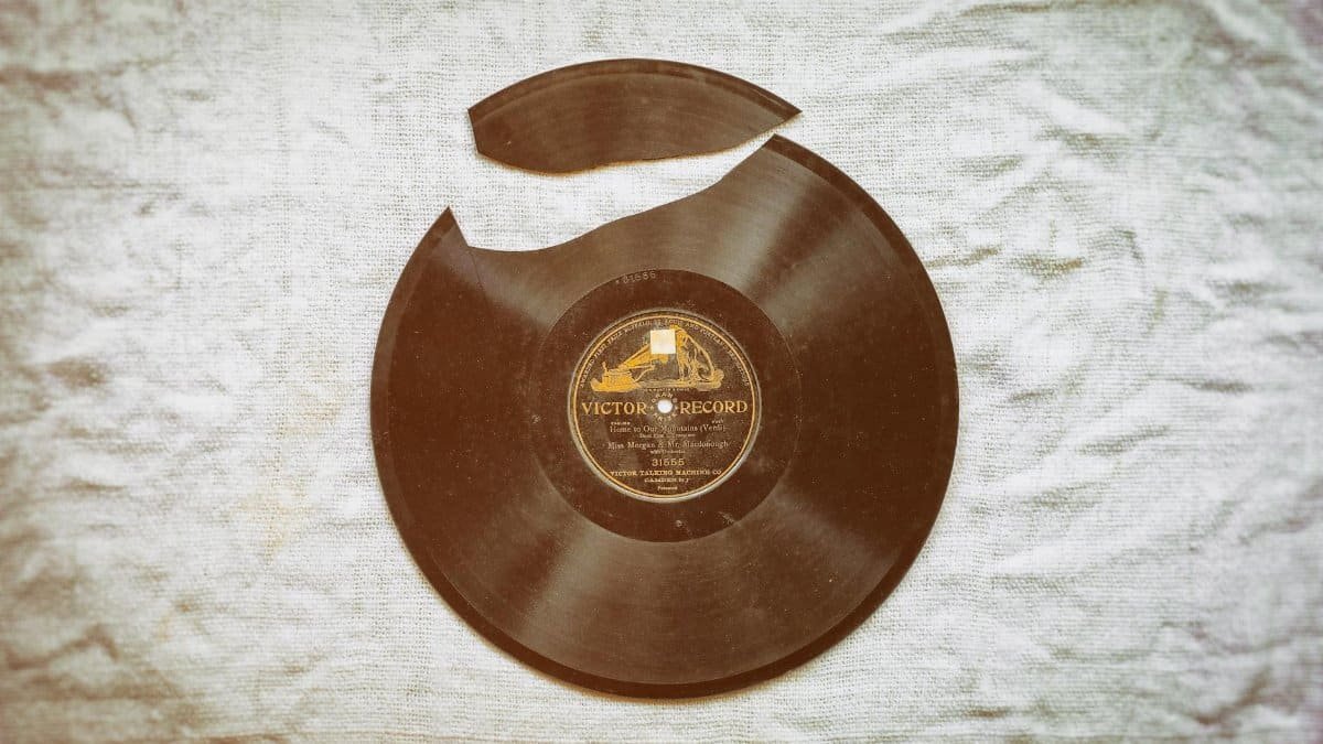 A close-up of a broken vintage vinyl record with nostalgic retro vibes on fabric.