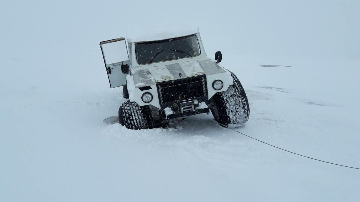 White 4x4 truck traversing snowy landscape in Karelia, Russia, showcasing adventure travel.