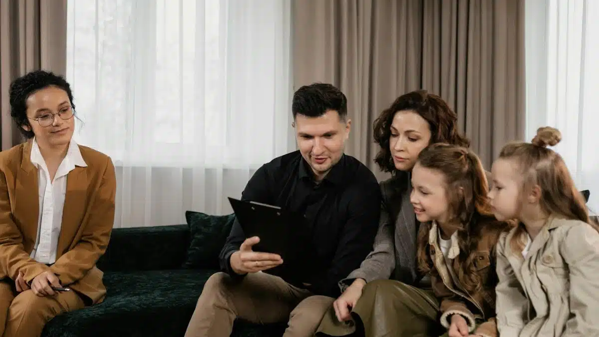 A family receiving advice from a professional advisor indoors, focused on financial planning.