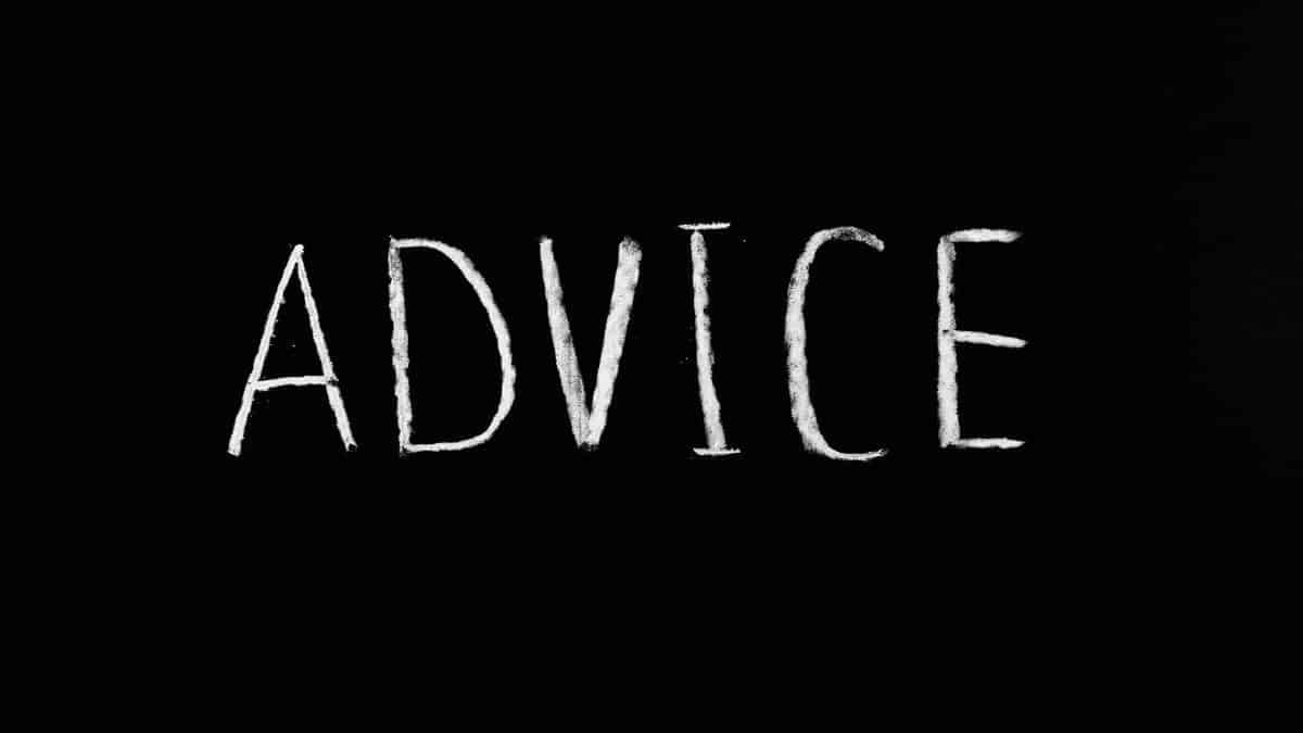 Inspirational word 'Advice' written in white chalk on blackboard.