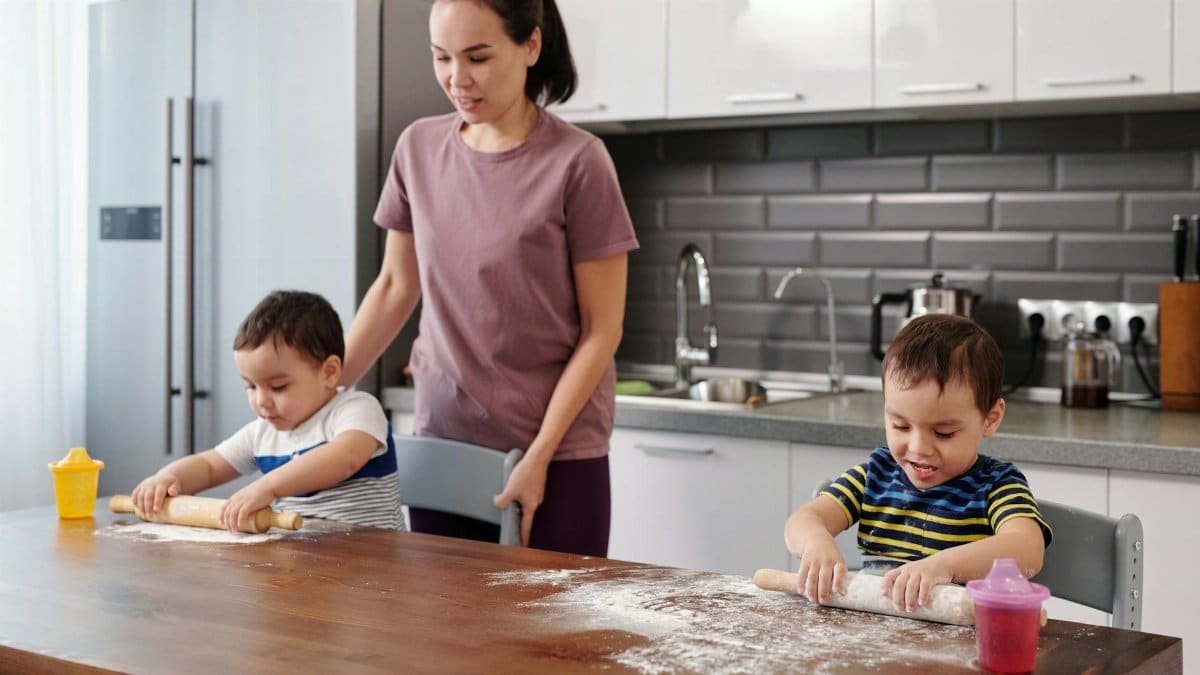 Mother and children baking together in a contemporary kitchen, fostering family bonds.