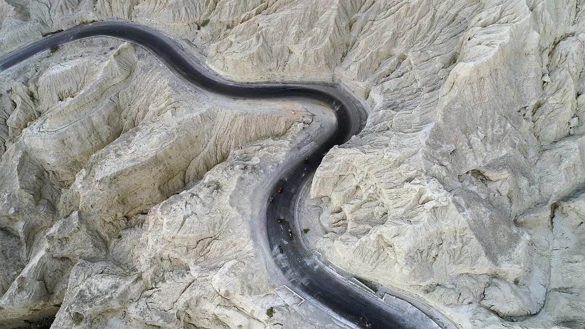 Drone shot capturing a winding road through rocky terrain in Balochistan, Pakistan.