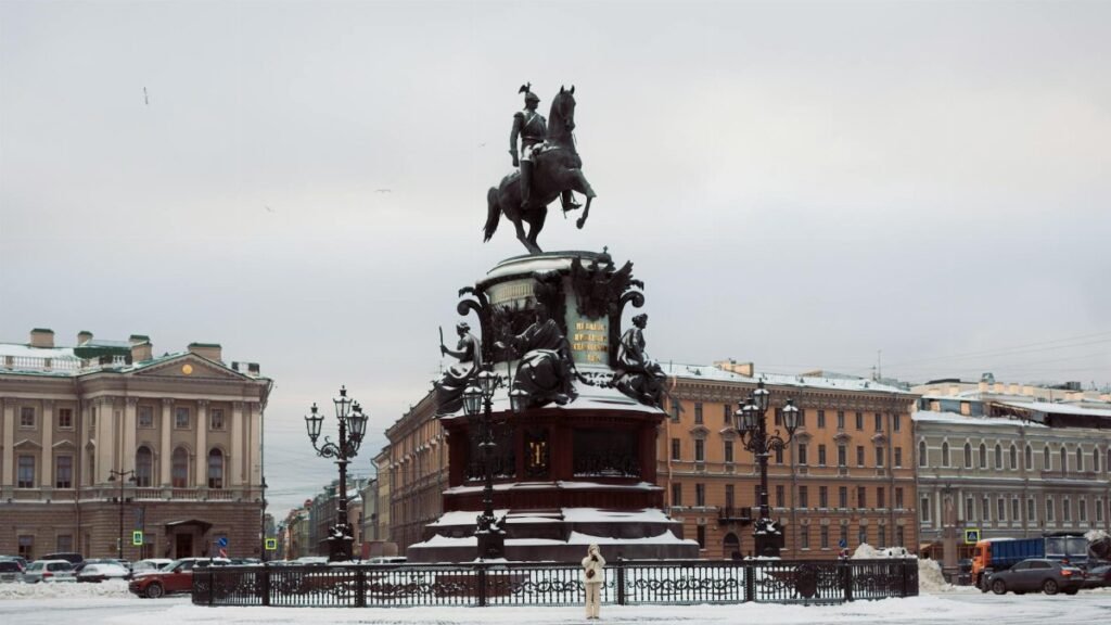 Snow-covered Monument to Nicholas I in Saint Petersburg's urban landscape.